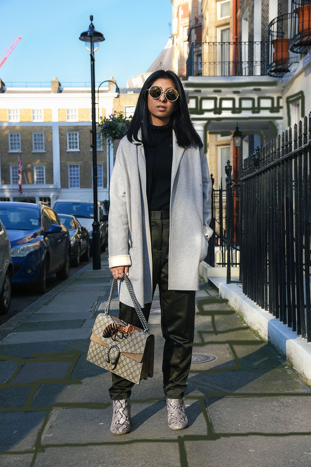 Fashion blogger Shloka Narang of The Silk Sneaker styles khaki Topshop pants and a Sandro sweater with a Gucci Bag