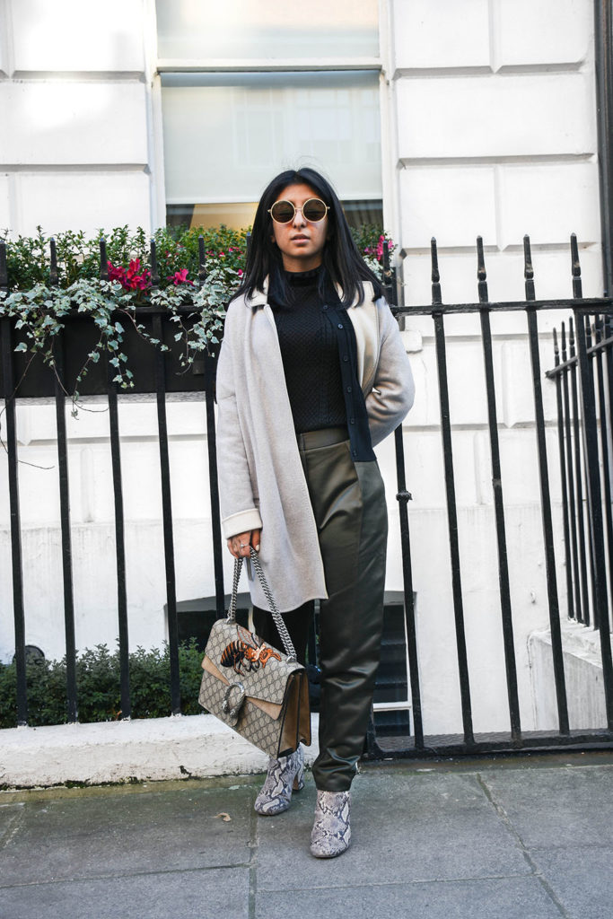 Fashion blogger Shloka Narang of The Silk Sneaker styles khaki Topshop pants and a Sandro sweater with a Gucci Bag