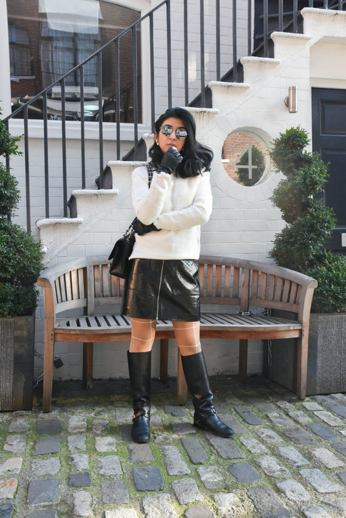 Fashion blogger Shloka Narang of The Silk Sneaker showcases how to style a vinyl skirt featuring a Mango skirt and Reiss sweater
