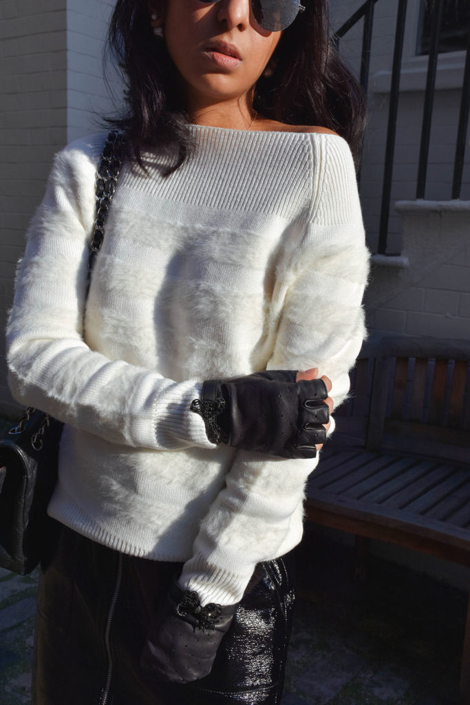 Fashion blogger Shloka Narang of The Silk Sneaker showcases how to style a vinyl skirt featuring a Mango skirt and Reiss sweater
