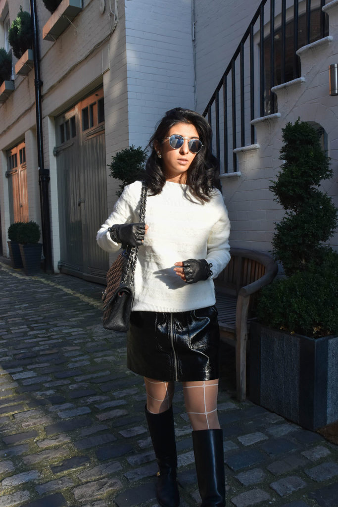 Fashion blogger Shloka Narang of The Silk Sneaker showcases how to style a vinyl skirt featuring a Mango skirt and Reiss sweater