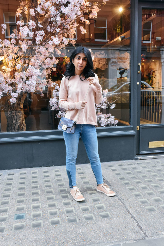 Fashion Blogger Shloka Narang of The Silk Sneaker showcases how to style and wear backless sweaters featuring this Furla bag