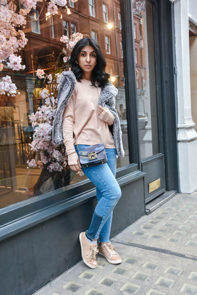 Fashion Blogger Shloka Narang of The Silk Sneaker showcases how to style and wear backless sweaters featuring this Furla bag