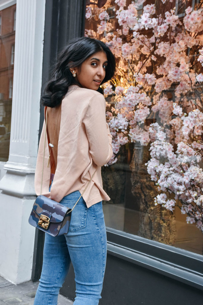 Fashion Blogger Shloka Narang of The Silk Sneaker showcases how to style and wear backless sweaters featuring this Furla bag