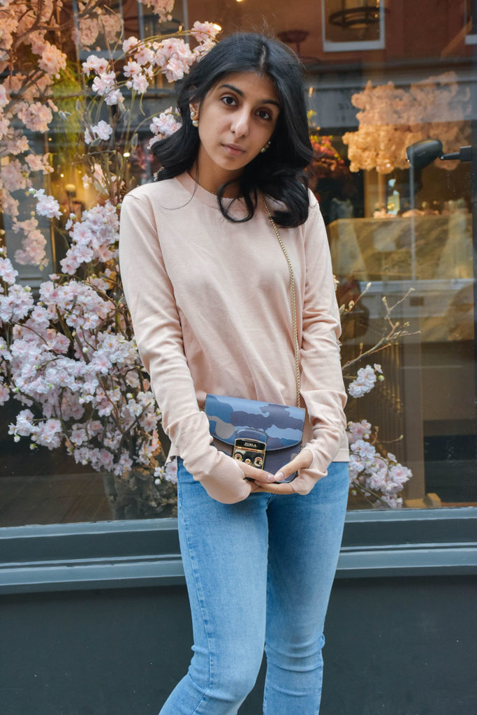 Fashion Blogger Shloka Narang of The Silk Sneaker showcases how to style and wear backless sweaters featuring this Furla bag