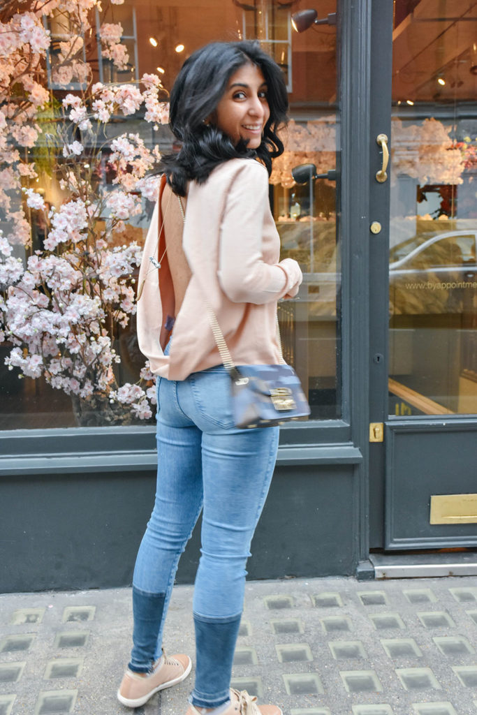 Fashion Blogger Shloka Narang of The Silk Sneaker showcases how to style and wear backless sweaters featuring this Furla bag