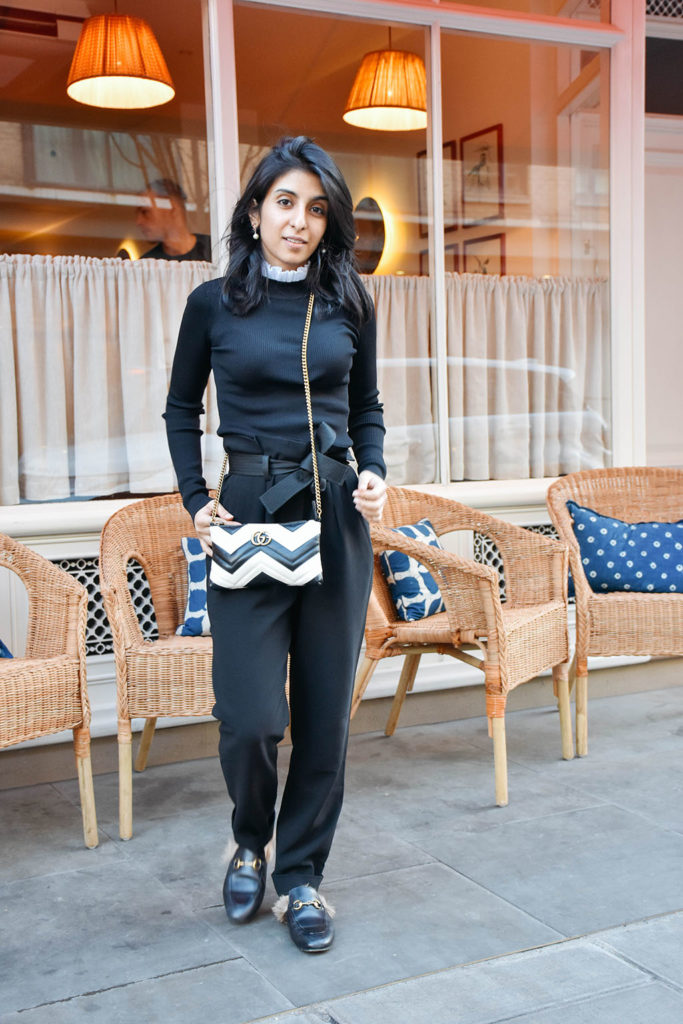 Fashion blogger Shloka Narang of The Silk Sneaker showcases a spring outfit with a spring sweater