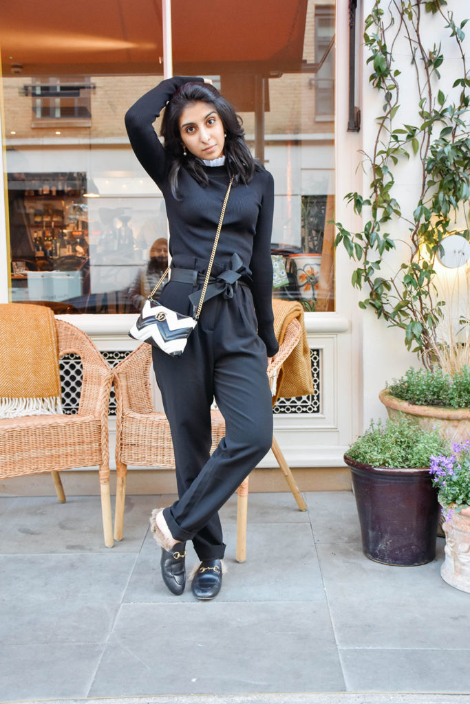 Fashion blogger Shloka Narang of The Silk Sneaker showcases a spring outfit with a spring sweater