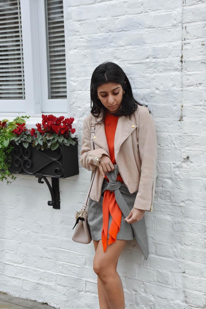 Fashion blogger Shloka Narang of The Silk Sneaker showcases how to combine spring colour combination pink and orange featuring Daniel Wellington