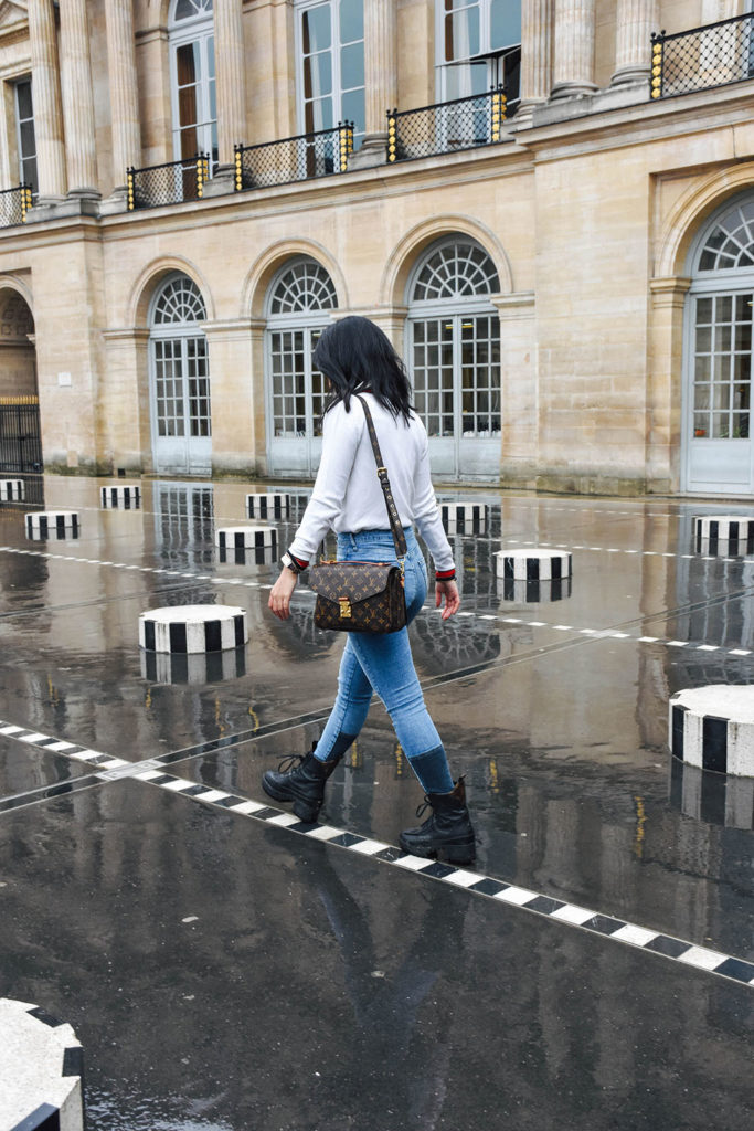 Fashion blogger Shloka Narang of The Silk Sneaker showcases a chic outfit in Paris featuring a Gucci Sweater