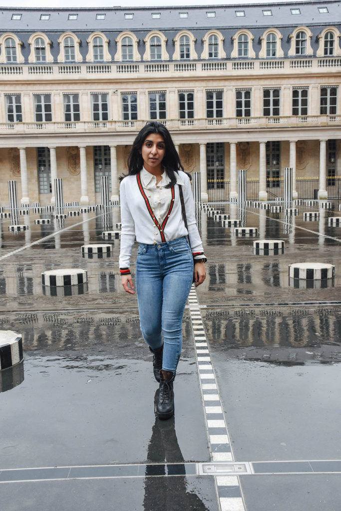 Fashion blogger Shloka Narang of The Silk Sneaker showcases a chic outfit in Paris featuring a Gucci Sweater