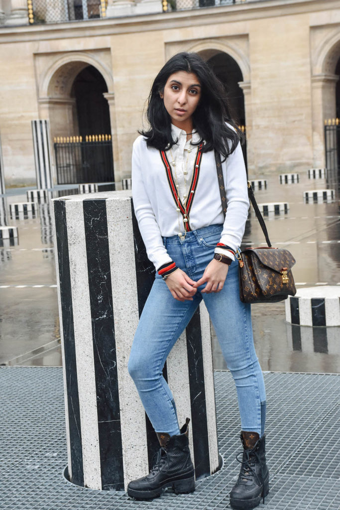 Fashion blogger Shloka Narang of The Silk Sneaker showcases a chic outfit in Paris featuring a Gucci Sweater