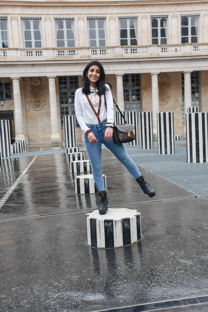 Fashion blogger Shloka Narang of The Silk Sneaker showcases a chic outfit in Paris featuring a Gucci Sweater