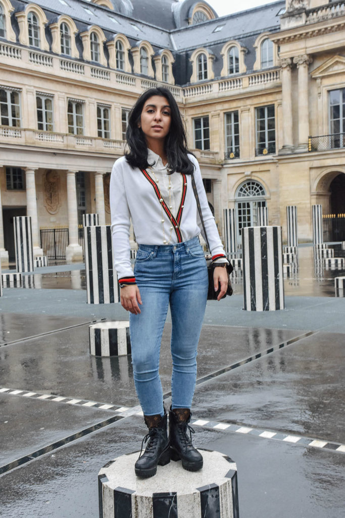 Fashion blogger Shloka Narang of The Silk Sneaker showcases a chic outfit in Paris featuring a Gucci Sweater