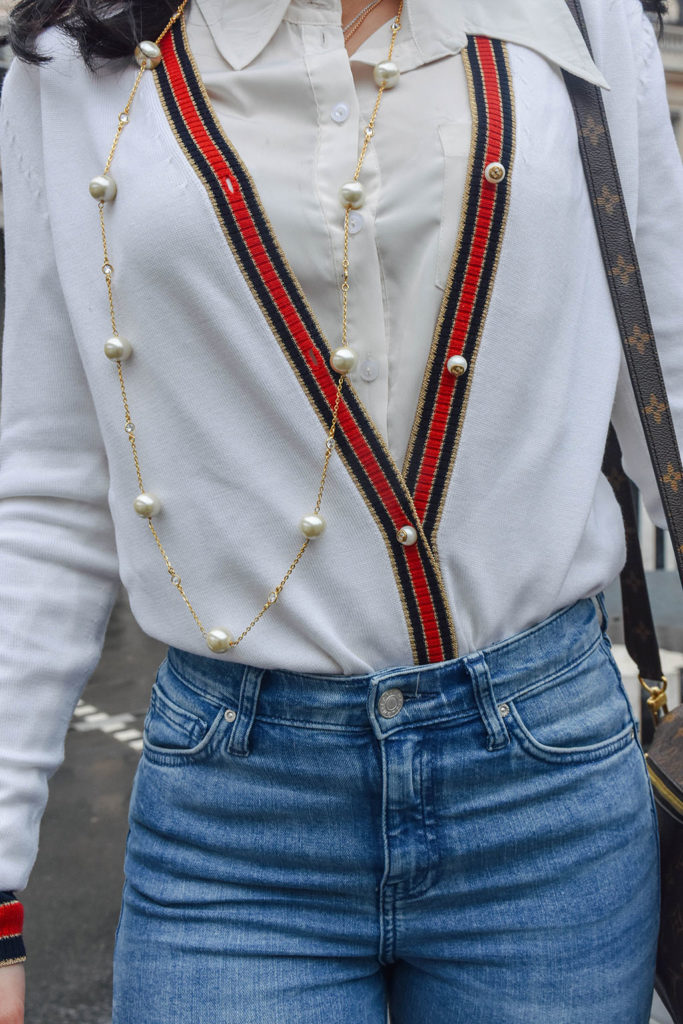 Fashion blogger Shloka Narang of The Silk Sneaker showcases a chic outfit in Paris featuring a Gucci Sweater