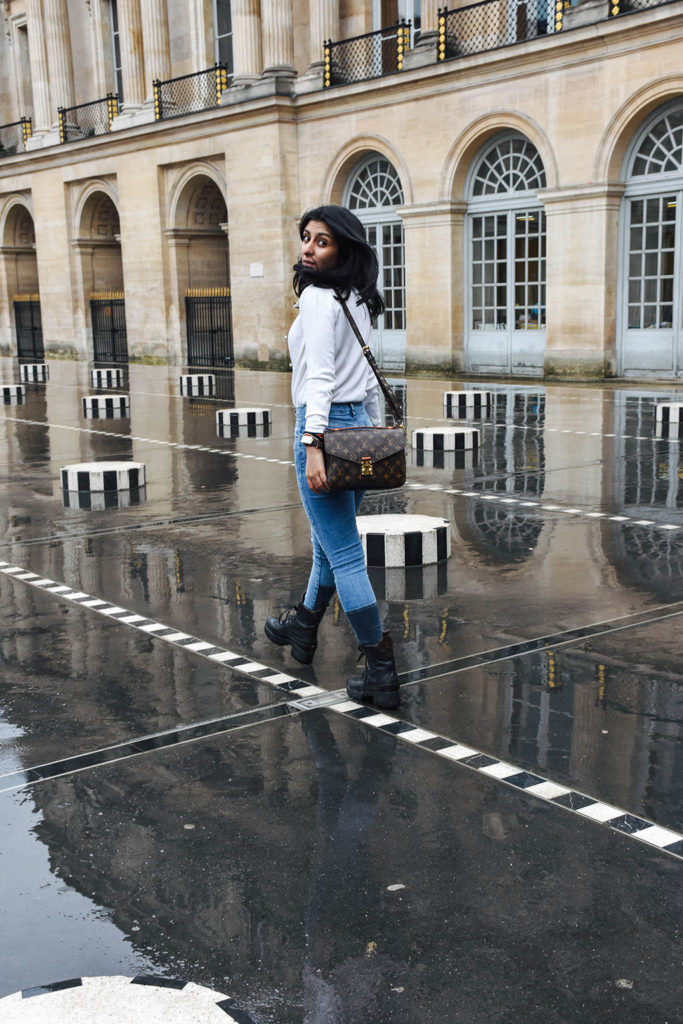 Fashion blogger Shloka Narang of The Silk Sneaker showcases a chic outfit in Paris featuring a Gucci Sweater