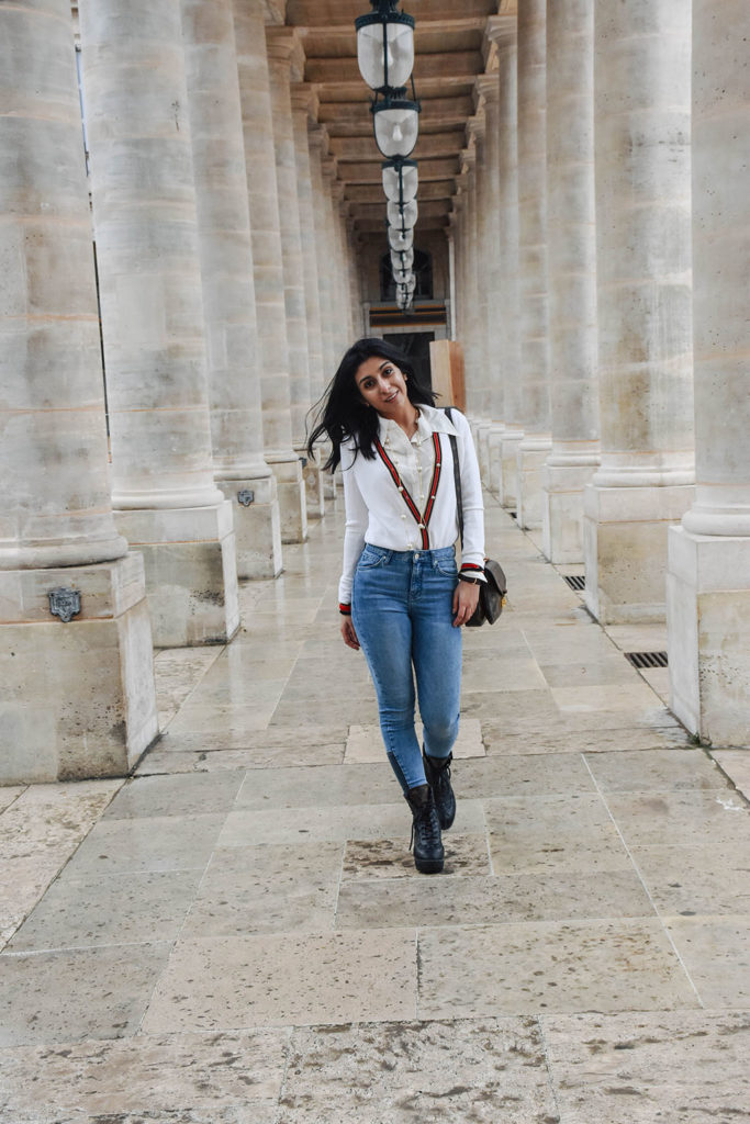 Fashion blogger Shloka Narang of The Silk Sneaker showcases a chic outfit in Paris featuring a Gucci Sweater