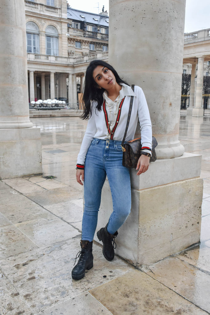 Fashion blogger Shloka Narang of The Silk Sneaker showcases a chic outfit in Paris featuring a Gucci Sweater