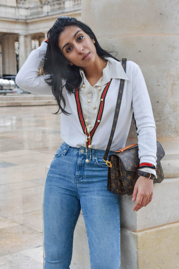 Fashion blogger Shloka Narang of The Silk Sneaker showcases a chic outfit in Paris featuring a Gucci Sweater