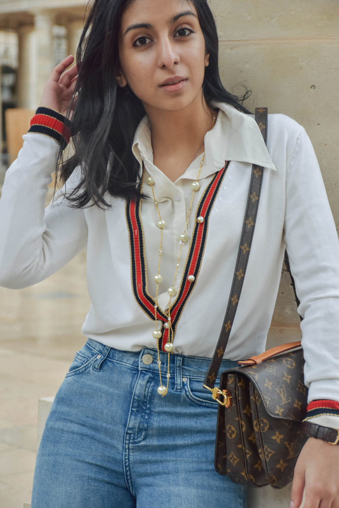 Fashion blogger Shloka Narang of The Silk Sneaker showcases a chic outfit in Paris featuring a Gucci Sweater