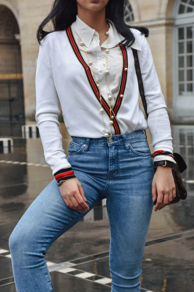 Fashion blogger Shloka Narang of The Silk Sneaker showcases a chic outfit in Paris featuring a Gucci Sweater