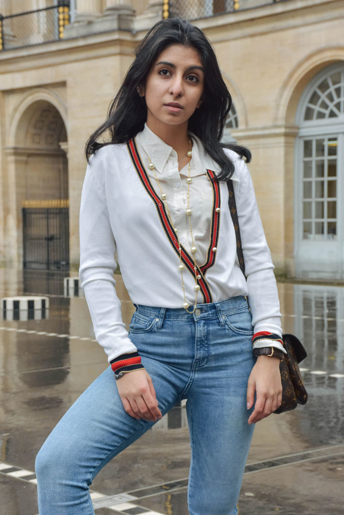 Fashion blogger Shloka Narang of The Silk Sneaker showcases a chic outfit in Paris featuring a Gucci Sweater