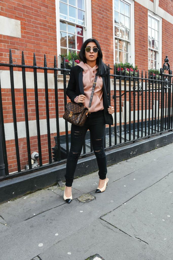 Fashion Blogger Shloka Narang of The Silk Sneaker showcases how to style a hoodie for everyday featuring Topshop hoodie and Frame Denim jeans