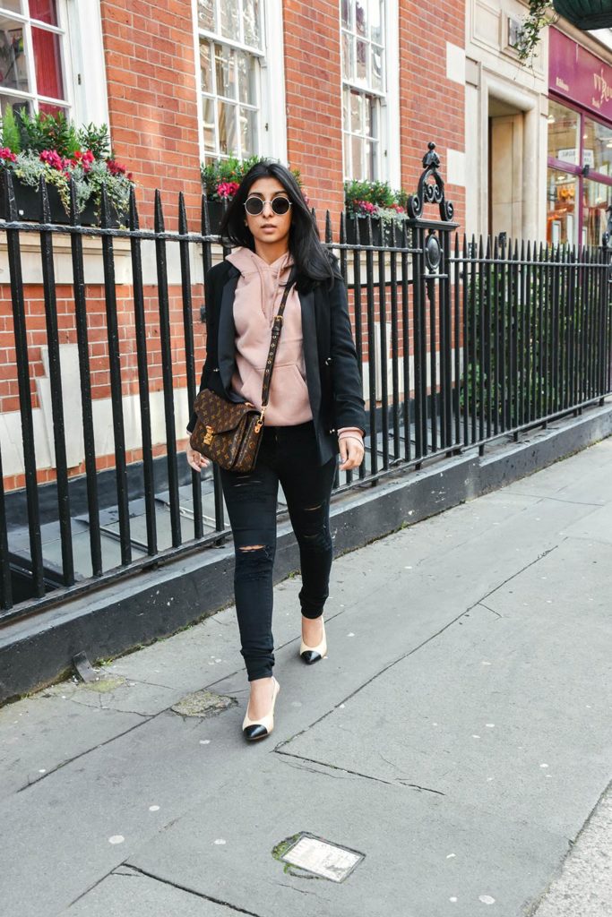 Fashion Blogger Shloka Narang of The Silk Sneaker showcases how to style a hoodie for everyday featuring Topshop hoodie and Frame Denim jeans