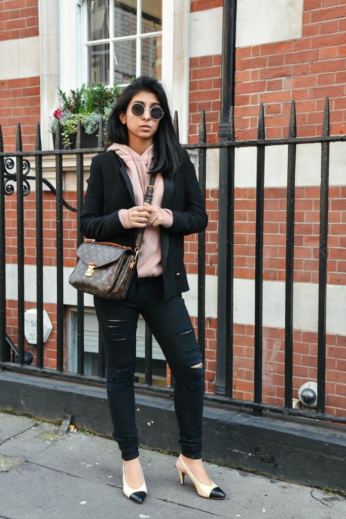 Fashion Blogger Shloka Narang of The Silk Sneaker showcases how to style a hoodie for everyday featuring Topshop hoodie and Frame Denim jeans