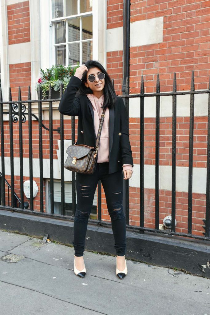 Fashion Blogger Shloka Narang of The Silk Sneaker showcases how to style a hoodie for everyday featuring Topshop hoodie and Frame Denim jeans