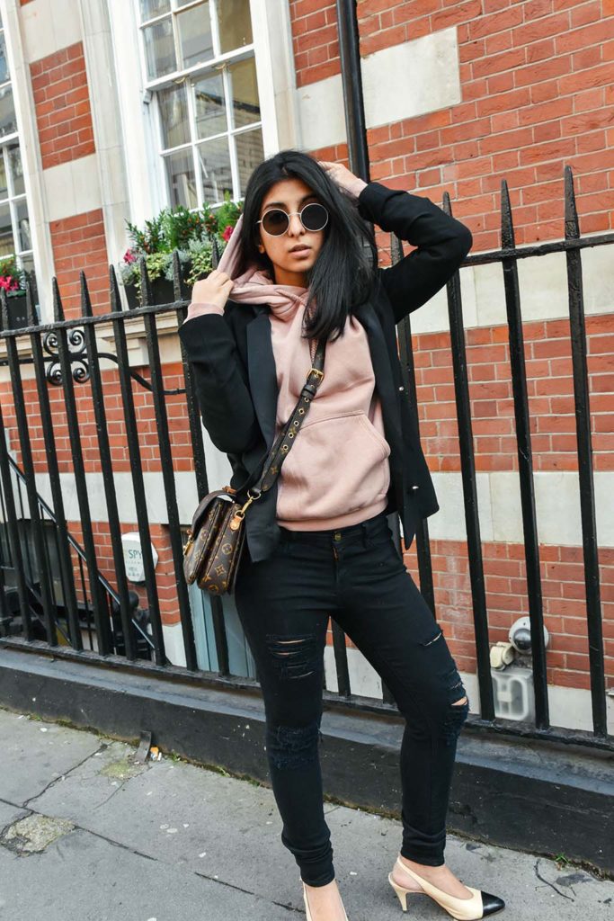 Fashion Blogger Shloka Narang of The Silk Sneaker showcases how to style a hoodie for everyday featuring Topshop hoodie and Frame Denim jeans