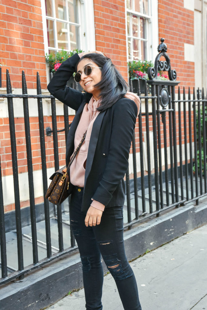Fashion Blogger Shloka Narang of The Silk Sneaker showcases how to style a hoodie for everyday featuring Topshop hoodie and Frame Denim jeans