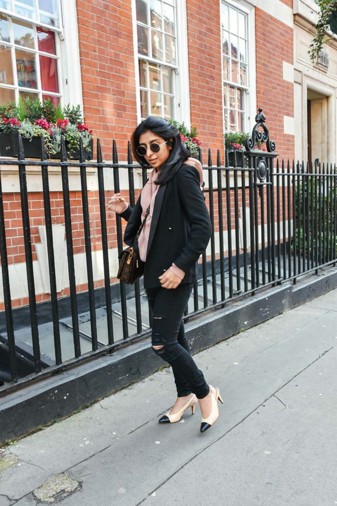 Fashion Blogger Shloka Narang of The Silk Sneaker showcases how to style a hoodie for everyday featuring Topshop hoodie and Frame Denim jeans