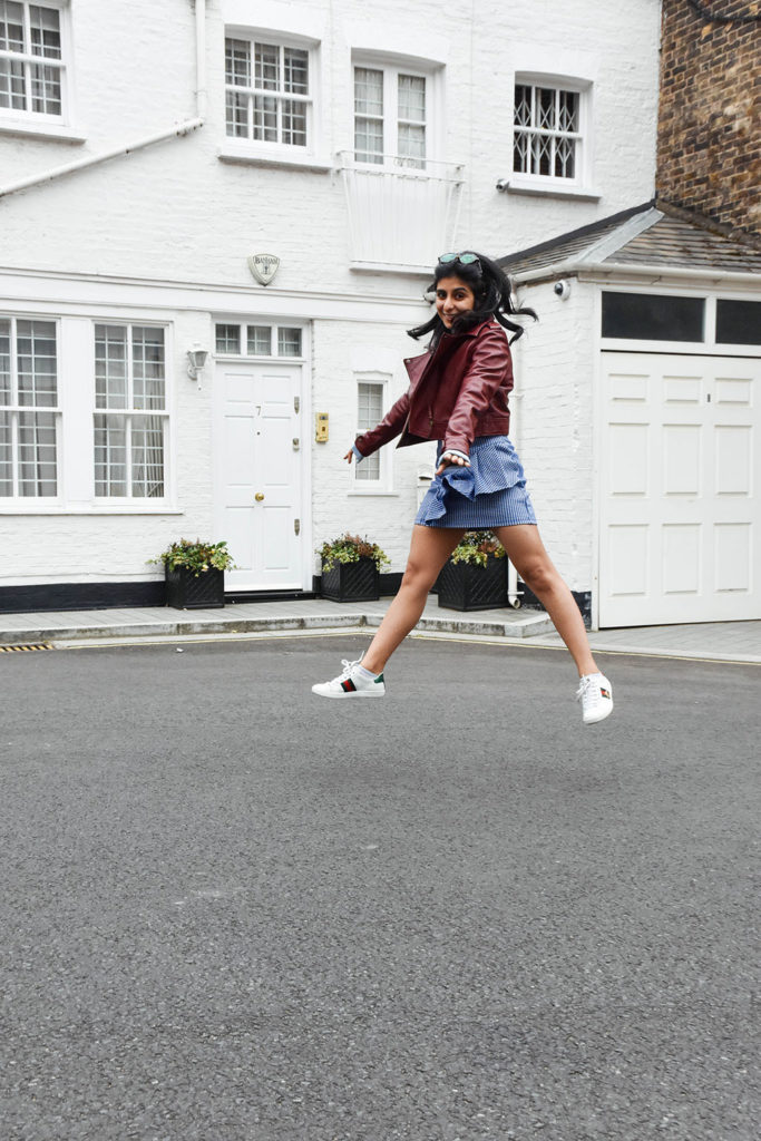 Fashion blogger Shloka Narang of The Silk Sneaker showcases how to wear gingham outfit featuring a Topshop Skirt and Gucci Sneakers