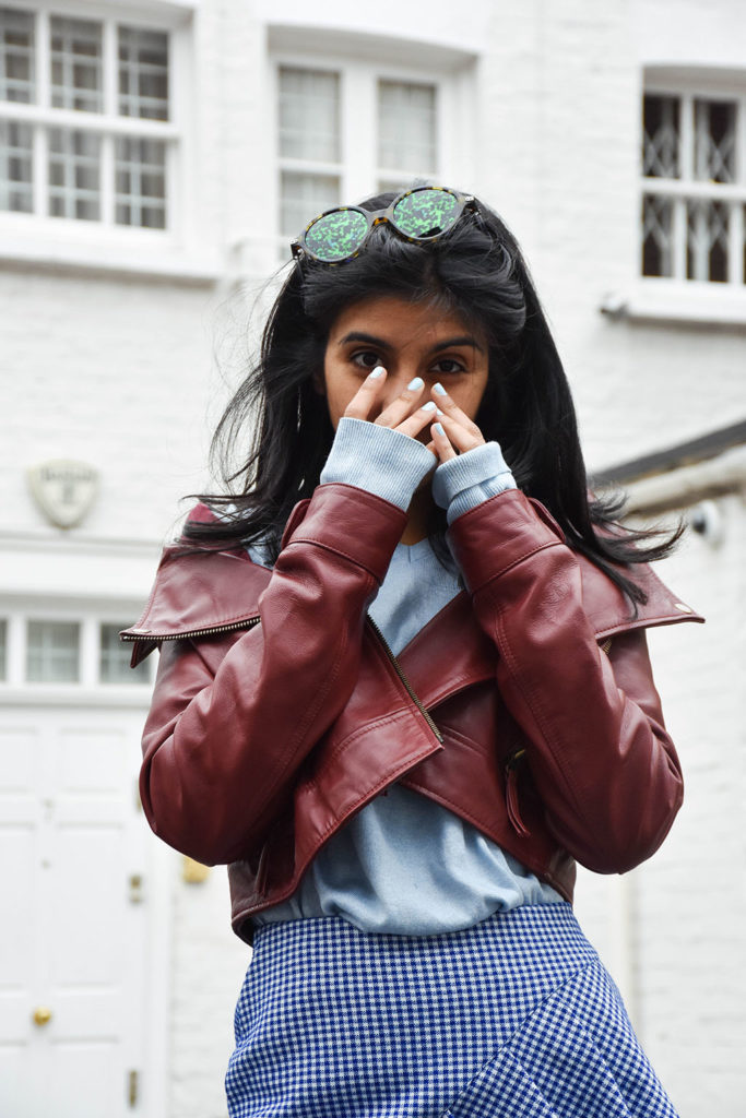 Fashion blogger Shloka Narang of The Silk Sneaker showcases how to wear gingham outfit featuring a Topshop Skirt and Gucci Sneakers
