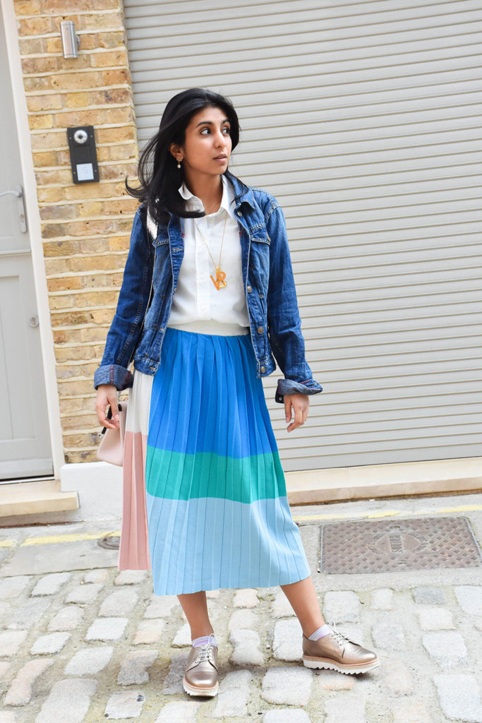 Fashion blogger Shloka Narang styles a maxi skirt outfit featuring a pastel colour block skirt and denim jacket
