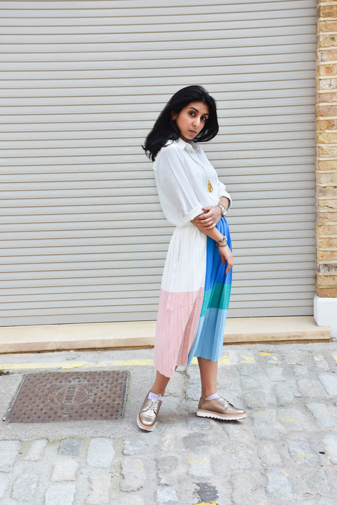 Fashion blogger Shloka Narang styles a maxi skirt outfit featuring a pastel colour block skirt and denim jacket