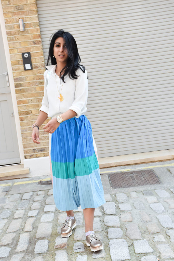 Fashion blogger Shloka Narang styles a maxi skirt outfit featuring a pastel colour block skirt and denim jacket