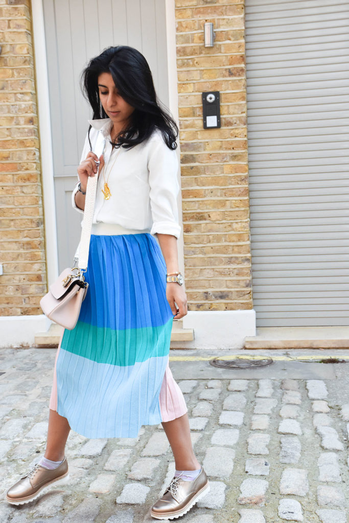 Fashion blogger Shloka Narang styles a maxi skirt outfit featuring a pastel colour block skirt and denim jacket