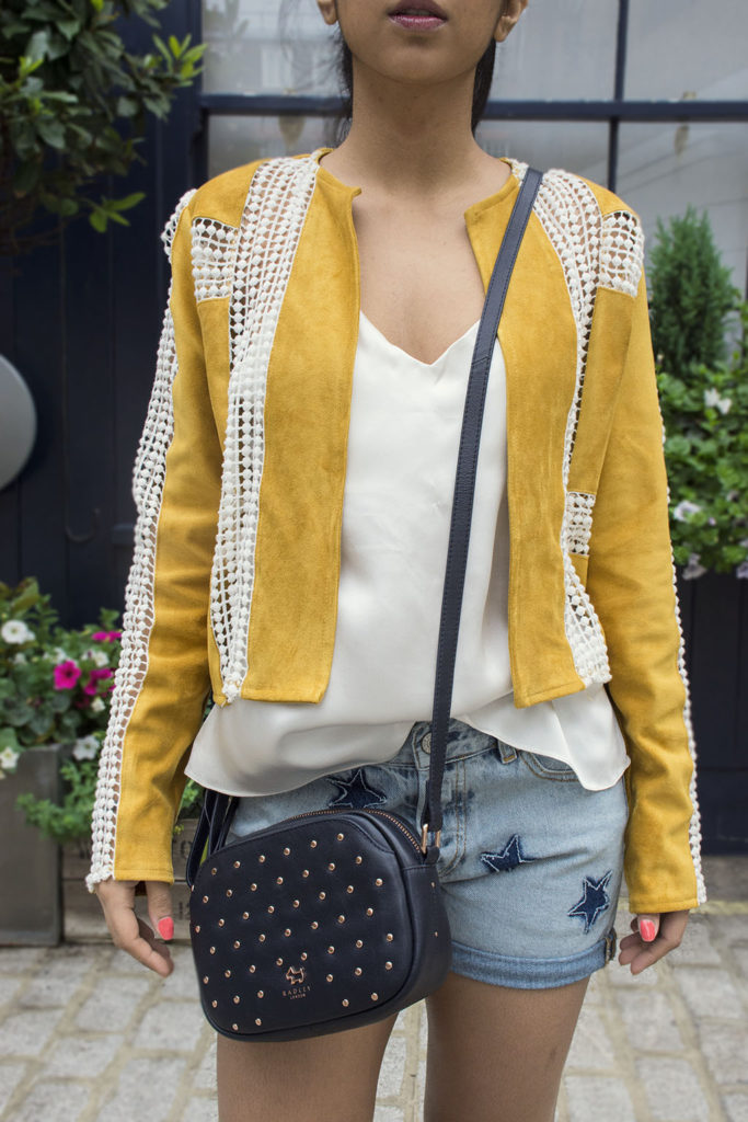 Fashion Blogger Shloka Narang of The Silk Sneaker showcases how to wear statement pieces with denim shorts and Radley Bag