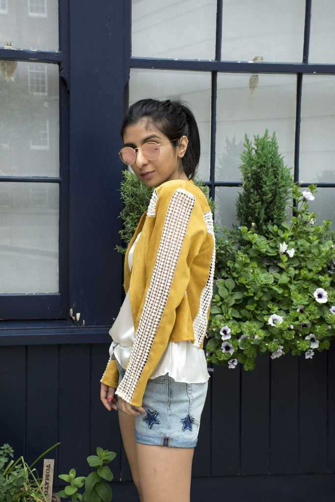 Fashion Blogger Shloka Narang of The Silk Sneaker showcases how to wear statement pieces with denim shorts and Radley Bag