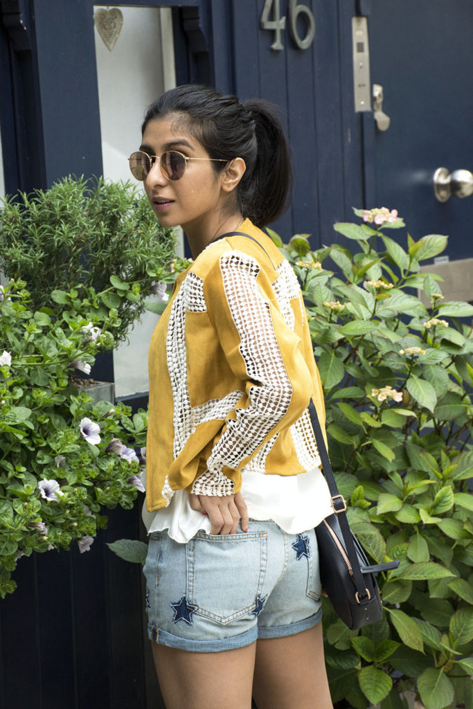 Fashion Blogger Shloka Narang of The Silk Sneaker showcases how to wear statement pieces with denim shorts and Radley Bag