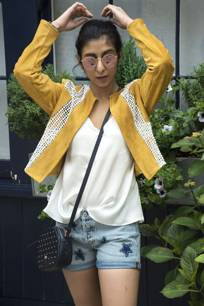 Fashion Blogger Shloka Narang of The Silk Sneaker showcases how to wear statement pieces with denim shorts and Radley Bag