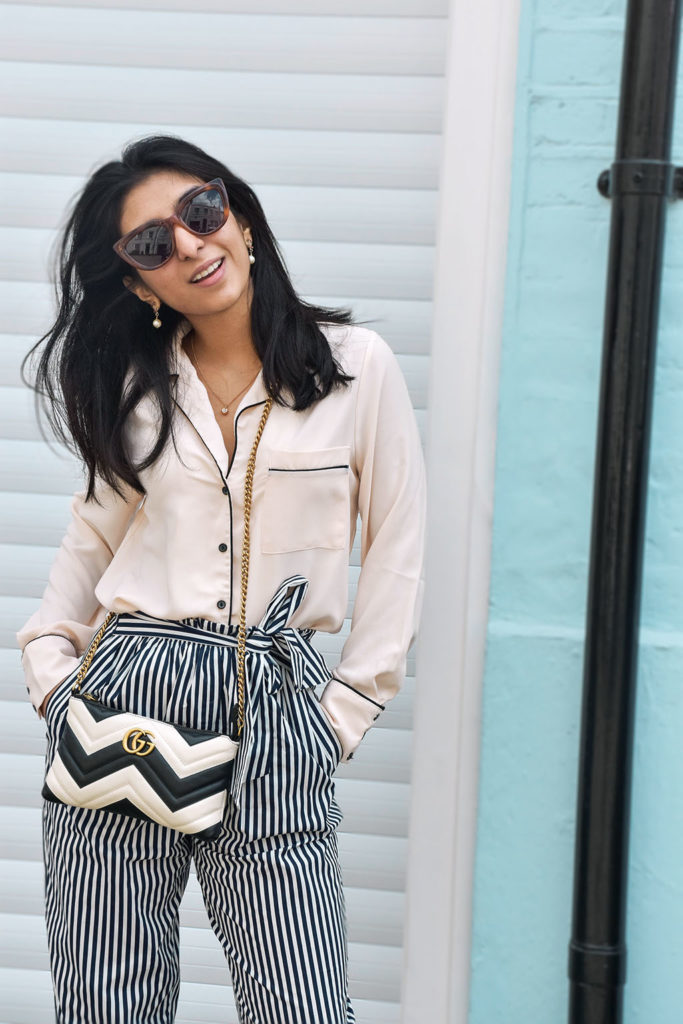Fashion blogger Shloka Narang showcases how to style striped pants featuring Topshop, Zara and Gucci
