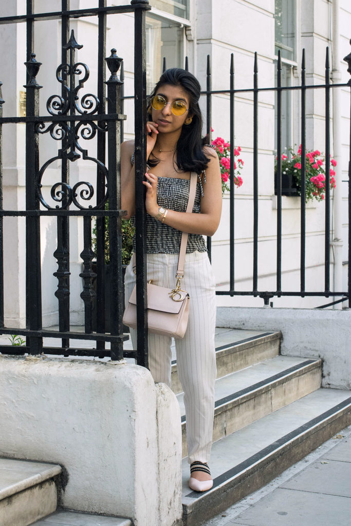 Fashion Blogger Shloka Narang of The Silk Sneaker showcases how to wear an easy summer outfit mixing gingham and stripes