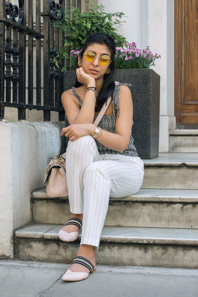 Fashion Blogger Shloka Narang of The Silk Sneaker showcases how to wear an easy summer outfit mixing gingham and stripes