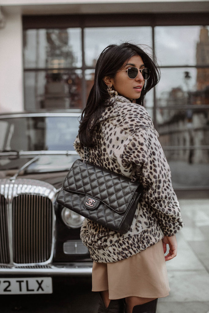Fashion blogger Shloka Narang of The Silk Sneaker shares how to style a leopard print coat featuring By Malene Birger, Maje and Chanel