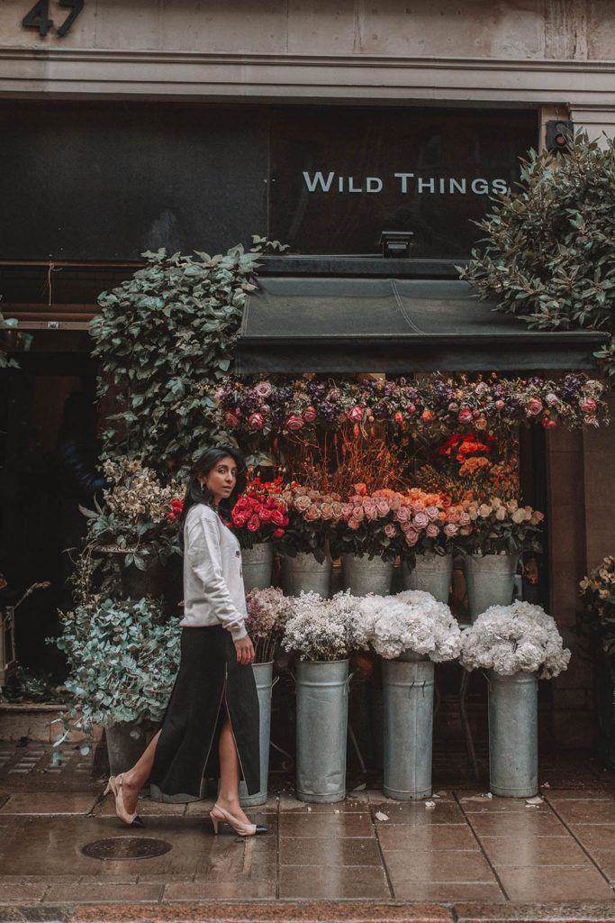 Fashion blogger Shloka Narang of The Silk Sneaker shares a style trick for how to style a statement sweater for a cozy and cute spring summer outfit featuring Ba&sh and Chanel