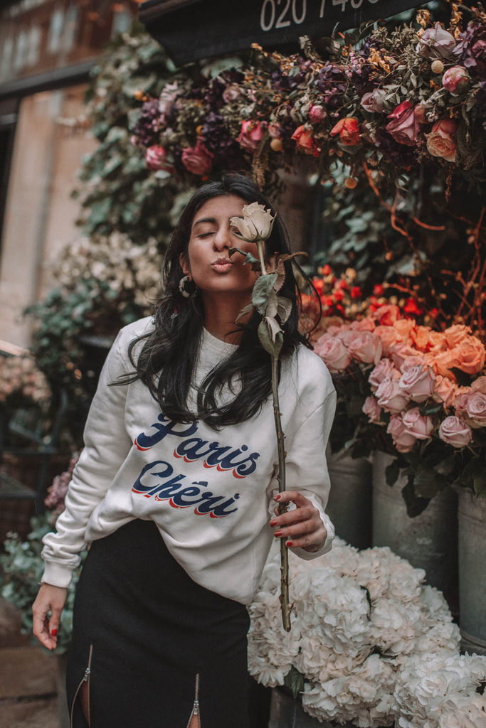 Fashion blogger Shloka Narang of The Silk Sneaker shares a style trick for how to style a statement sweater for a cozy and cute spring summer outfit featuring Ba&sh and Chanel