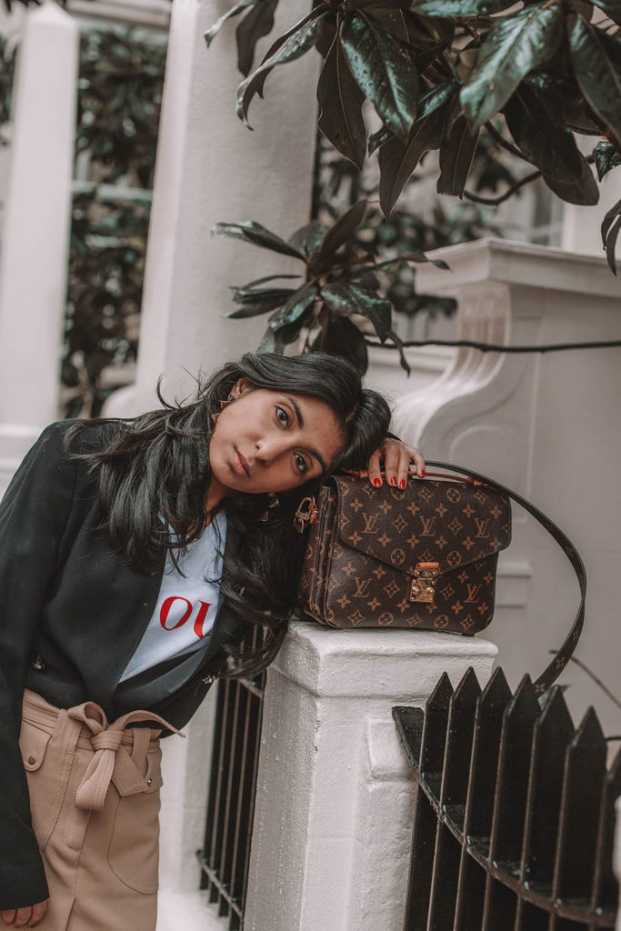Fashion blogger Shloka Narang of The Silk Sneaker shares her style trick in how to style a blazer for a casual spring outfit idea featuring River Island, Maje, Louis Vuitton and Chanel